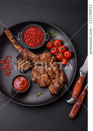 Juicy beef tomahawk steak on the bone baked on the grill 115790912