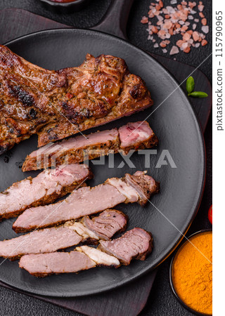 Juicy beef tomahawk steak on the bone baked on the grill Juicy beef tomahawk steak on the bone baked on the grill 115790965