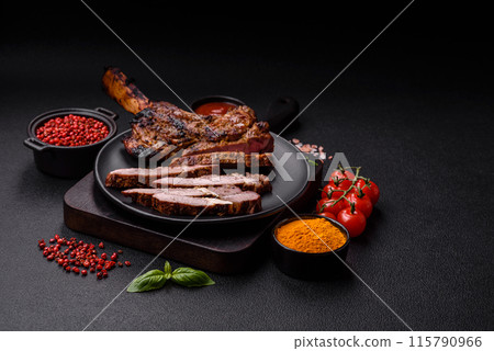 Juicy beef tomahawk steak on the bone baked on the grill 115790966