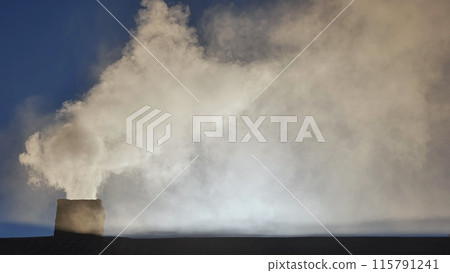 Silhouette of smoke against blue sky from the chimney of a village house. Silhouette of smoke against blue sky from the chimney of a village house. 115791241
