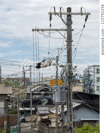 Utility poles and wires in a densely populated residential area Utility poles and wires in a densely populated residential area 115791256