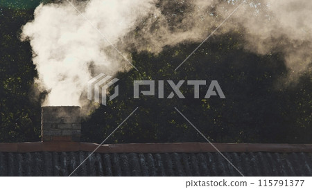 White smoke from the chimney of the village house. 115791377
