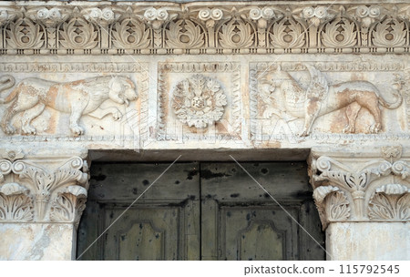 Stone carvings on the portal of Santa Maria Forisportam church in Lucca, Tuscany, Italy Stone carvings on the portal of Santa Maria Forisportam church in Lucca, Tuscany, Italy 115792545