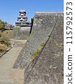 Kumamoto Castle under a clear blue sky: The castle tower and two stone walls 115792573