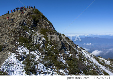 Climbers gather at the summit in autumn Climbers gather at the summit in autumn 115792671