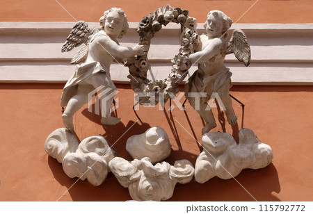 Angels, statue on the portal of St. Barnabas Church in Modena, Italy 115792772