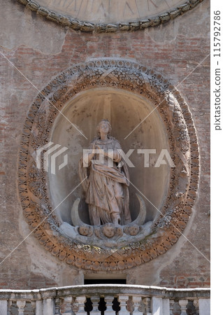 Virgin Mary statue on Clock tower of Palace of Reason (Palazzo della Ragione with the Torre dell'Orologio) in Mantua, Italy Virgin Mary statue on Clock tower of Palace of Reason (Palazzo della Ragione with the Torre dell'Orologio) in Mantua, Italy 115792786