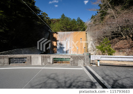 A blue river with an artificial waterfall flowing through Kirishima A blue river with an artificial waterfall flowing through Kirishima 115793683