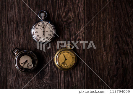Collection of Antique Pocket Watches with Various Designs on Wooden Background 115794009