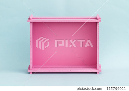Vibrant Pink Wooden Box Against Light Blue Background, Minimalist Design 115794021