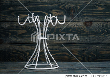 Empty white mug hanger against a blue wooden background with copy space. Empty white mug hanger against a blue wooden background with copy space. 115794053