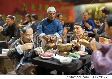 Chinese figures in restaurant at famous Qianmen pedestrian commercial street in Beijing Chinese figures in restaurant at famous Qianmen pedestrian commercial street in Beijing 115794775