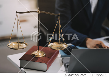 Male lawyer working with contract papers and wooden gavel on tabel in courtroom. justice and law ,attorney, court judge, concept. Male lawyer working with contract papers and wooden gavel on tabel in courtroom. justice and law ,attorney, court judge, concept. 115795515