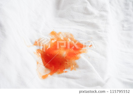 Dirty tomato sauce stain or ketchup on cloth to wash with washing powder, cleaning housework concept. 115795552