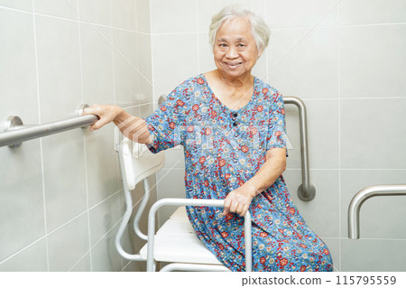 Asian elderly old woman patient use toilet support rail in bathroom, handrail safety grab bar, security in nursing hospital. Asian elderly old woman patient use toilet support rail in bathroom, handrail safety grab bar, security in nursing hospital. 115795559