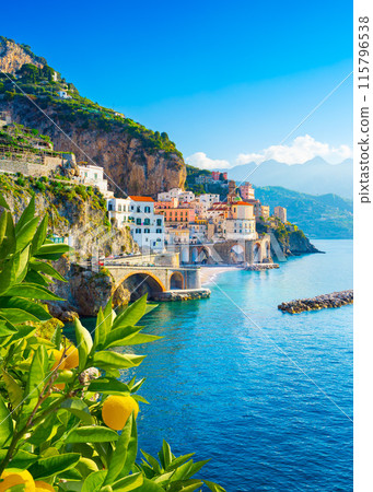 Beautiful view of Amalfi on the Mediterranean coast with lemons in the foreground, Italy Beautiful view of Amalfi on the Mediterranean coast with lemons in the foreground, Italy 115796538