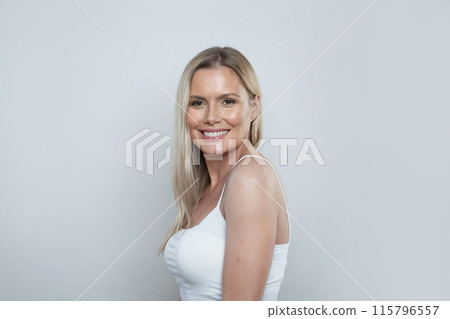 Attractive young blonde woman with long hair and healthy clean fresh skin standing Attractive young blonde woman with long hair and healthy clean fresh skin standing 115796557