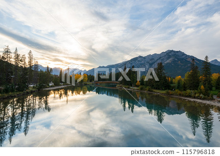 Banff National Park in autumn. Beautiful natural scenery reflected on Bow River like a mirror. Mount Norquay, Town of Banff, Canadian Rockies. 115796818