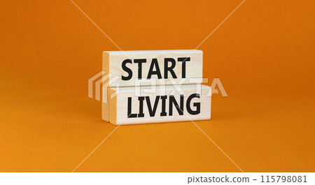 Start living symbol. Concept words Start living on beautiful wooden block. Beautiful orange table orange background. Business and Start living concept. Copy space. Start living symbol. Concept words Start living on beautiful wooden block. Beautiful orange table orange background. Business and Start living concept. Copy space. 115798081