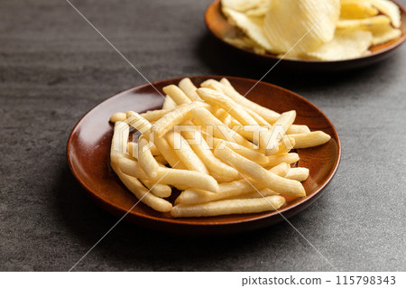 Potato chips and french fries snack in dish. Potato chips and french fries snack in dish. 115798343