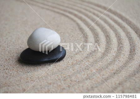 White and black zen stones on sand with customizable space for text. White and black zen stones on sand with customizable space for text. 115798481