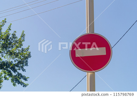 A road sign prohibiting movement in vehicles in this direction is installed on a street lighting pole. In the popular understanding, it is called a brick. A road sign prohibiting movement in vehicles in this direction is installed on a street lighting pole. In the popular understanding, it is called a brick. 115798769