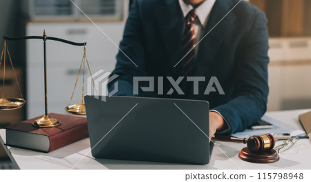 Male lawyer working with contract papers and wooden gavel on tabel in courtroom. justice and law ,attorney, court judge, concept. 115798948