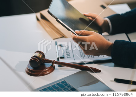 Male lawyer working with contract papers and wooden gavel on tabel in courtroom. justice and law ,attorney, court judge, concept. 115798964