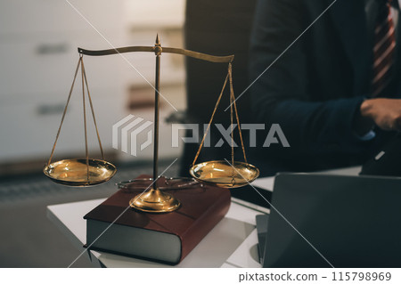 Male lawyer working with contract papers and wooden gavel on tabel in courtroom. justice and law ,attorney, court judge, concept. Male lawyer working with contract papers and wooden gavel on tabel in courtroom. justice and law ,attorney, court judge, concept. 115798969