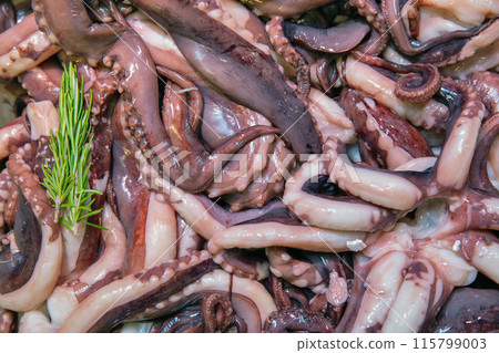 Fresh octopus tentacles delectable seafood delicacy closeup backfround 115799003