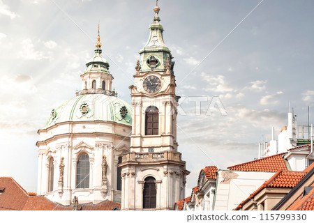 St. Nicholas Church tower and dome rising above Prague rooftops. Czech Republic 115799330