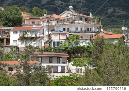 Traditional mediterranean houses are crowding on the mountain slope in Agros village. Limassol District, Cyprus 115799336