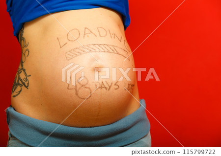 Pregnant woman with loading concept painted on her belly Pregnant woman with loading concept painted on her belly 115799722