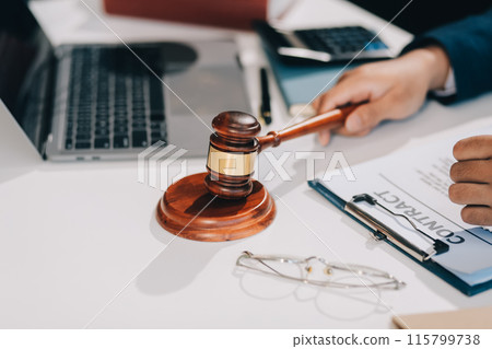 Male lawyer working with contract papers and wooden gavel on tabel in courtroom. justice and law ,attorney, court judge, concept. 115799738