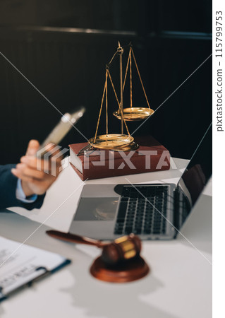 Male lawyer working with contract papers and wooden gavel on tabel in courtroom. justice and law ,attorney, court judge, concept. Male lawyer working with contract papers and wooden gavel on tabel in courtroom. justice and law ,attorney, court judge, concept. 115799753