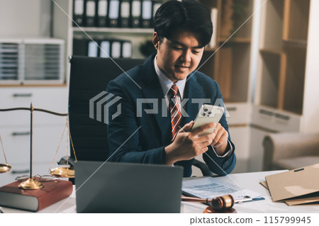 Male lawyer working with contract papers and wooden gavel on tabel in courtroom. justice and law ,attorney, court judge, concept. 115799945