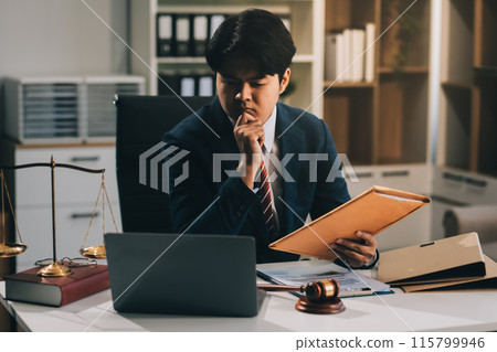 Male lawyer working with contract papers and wooden gavel on tabel in courtroom. justice and law ,attorney, court judge, concept. 115799946