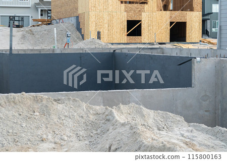 An ongoing construction site in the suburbs, featuring the foundation stage of a single-family house. An ongoing construction site in the suburbs, featuring the foundation stage of a single-family house. 115800163
