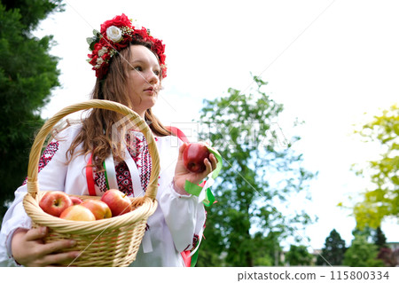 Ukrainian girl apples young woman in traditional Russian clothes with a basket of apples in hands forest. Slow motion 115800334
