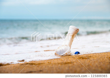 Used plastic bottle and disposable plastic container wash ashore on a tropical beach, highlighting the global crisis of plastic pollution on even the most remote islands Used plastic bottle and disposable plastic container wash ashore on a tropical beach, highlighting the global crisis of plastic pollution on even the most remote islands 115800365