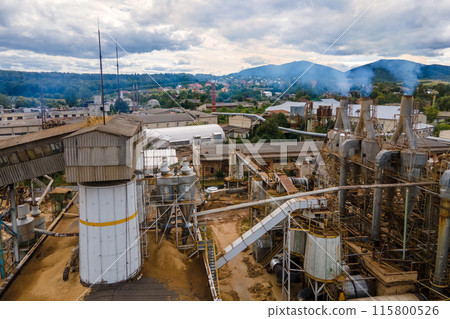Aerial view of wood processing factory with smoke from production process polluting atmosphere at plant manufacturing yard 115800526