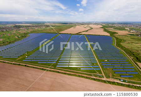 Aerial view of big sustainable electric power plant with many rows of solar photovoltaic panels for producing clean ecological electrical energy. Renewable electricity with zero emission concept. 115800530