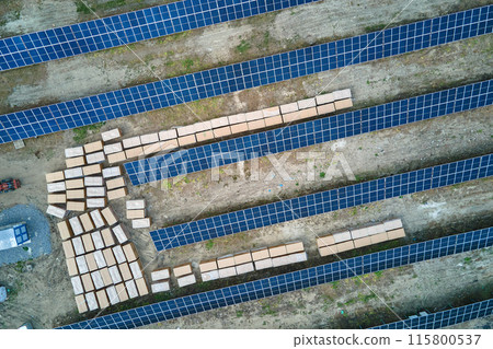 Aerial view of big electric power plant under construction with many rows of solar panels on metal frame for producing clean electrical energy. Development of renewable electricity sources 115800537