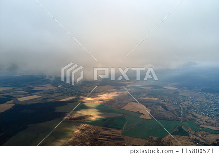 Aerial view from high altitude of earth covered with puffy rainy clouds forming before rainstorm Aerial view from high altitude of earth covered with puffy rainy clouds forming before rainstorm 115800571
