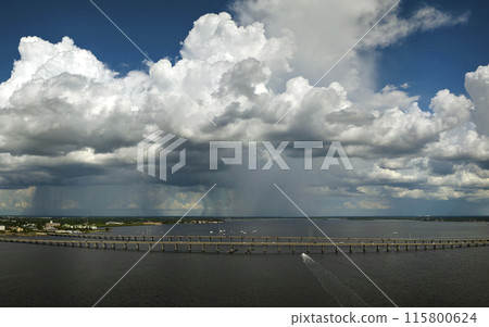 Heavy thunderstorm approaching traffic bridge connecting Punta Gorda and Port Charlotte over Peace River. Bad weather conditions for driving during rainy season in Florida Heavy thunderstorm approaching traffic bridge connecting Punta Gorda and Port Charlotte over Peace River. Bad weather conditions for driving during rainy season in Florida 115800624