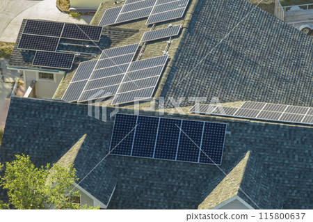 American residential house with rooftop covered with solar photovoltaic panels for producing of clean ecological electrical energy in suburban rural area. Concept of autonomous home American residential house with rooftop covered with solar photovoltaic panels for producing of clean ecological electrical energy in suburban rural area. Concept of autonomous home 115800637