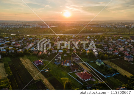 Aerial view of residential houses in suburban rural area at sunset Aerial view of residential houses in suburban rural area at sunset 115800667