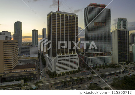 Downtown district of of Miami Brickell in Florida, USA at sunset. High skyscraper buildings and street with cars and Metrorail traffic in modern american midtown Downtown district of of Miami Brickell in Florida, USA at sunset. High skyscraper buildings and street with cars and Metrorail traffic in modern american midtown 115800712