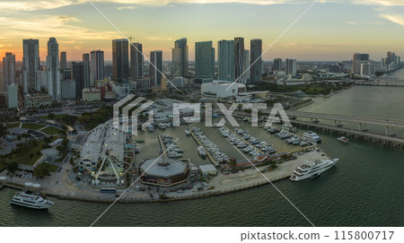 Aerial view of Skyviews Miami Observation Wheel at Bayside Marketplace with reflections in Biscayne Bay water and high illuminated skyscrapers of Brickell, city's financial center at sunset 115800717