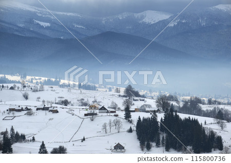 Winter landscape with small rural houses in remote settlement between snow covered forest in cold mountains Winter landscape with small rural houses in remote settlement between snow covered forest in cold mountains 115800736